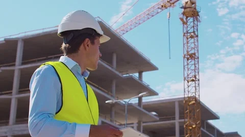 Professional builder standing in front of construction site. Foreman in hardhat Stock Footage 307937648