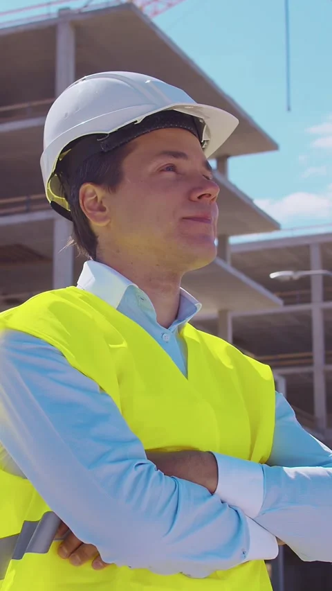 Professional builder standing in front of construction site. Foreman in hardhat Stock Footage 307938877