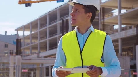 Professional builder standing in front of construction site. Foreman in hardhat Stock Footage 308479599