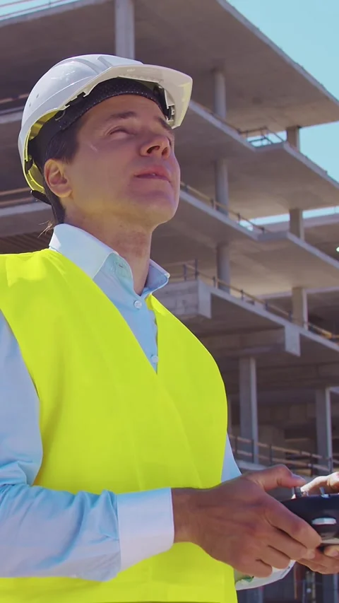 Professional builder standing in front of construction site. Foreman in hardhat Stock Footage 308480339