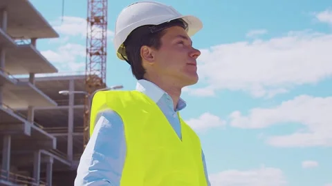 Professional builder standing in front of construction site. Foreman in hardhat Stock Footage 308933815