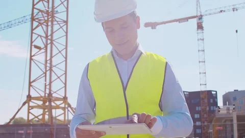 Professional builder standing in front of construction site. Foreman in hardhat Stock Footage 308934240