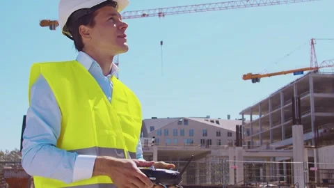 Professional builder standing in front of construction site. Foreman in hardhat Stock Footage 308934777
