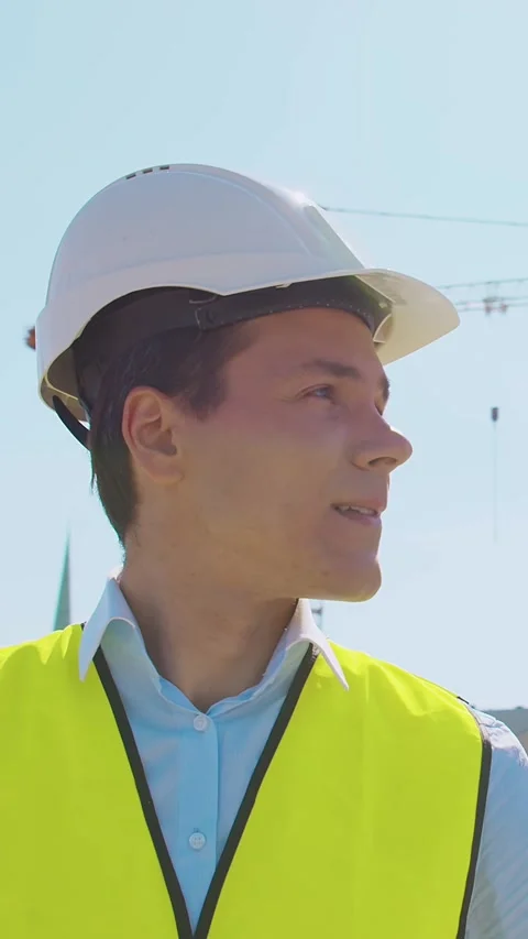 Professional builder standing in front of construction site. Foreman in hardhat Stock Footage 308935615