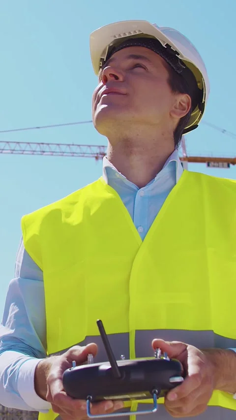 Professional builder standing in front of construction site. Foreman in hardhat Stock Footage 308935982