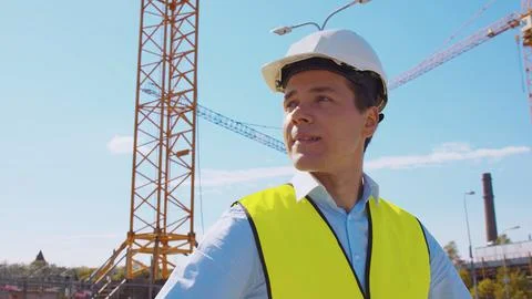 Professional builder standing in front of construction site. Foreman in hardhat Stock Photos