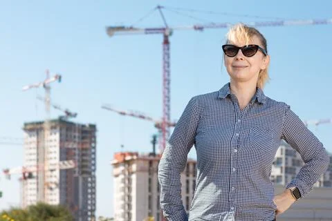 Professional builder standing with notebook in front of the construction site Stock Photos