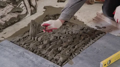 Professional builder worker installing floor a ceramic tile at repair. Stock Footage 328982662