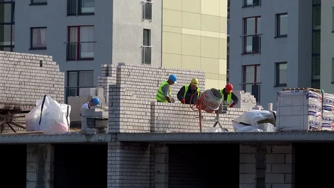 Professional builders men building brick wall on construction site. Panorama Stock Footage 106146823