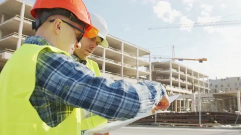 Professional builders standing in front of construction site. Office building Video stock 138553829