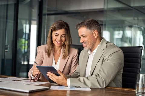 Professional business managers working using tablet at office meeting. Stock Photos