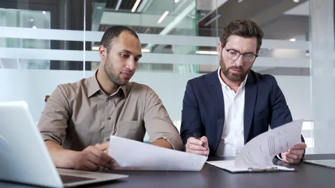 Professional business meeting between two male colleagues in modern office,  Stock-Footage 338059286