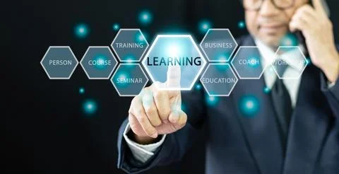 Professional businessman click a learning button on a virtual screen techno.. Stock Photos