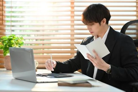 Professional businessman using laptop computer and checking his working schedule Stock Photos