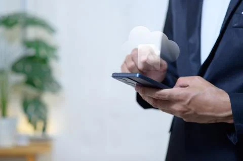 Professional Businessman Using Smartphone with Cloud Technology in Office S.. Stock Photos
