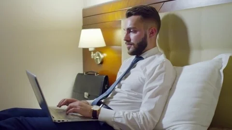 Professional Businessman Working on Laptop in Bed Stock Footage