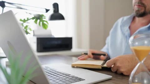 Professional businessman writing notes in a notebook while working at his l.. Stock Footage 341625242