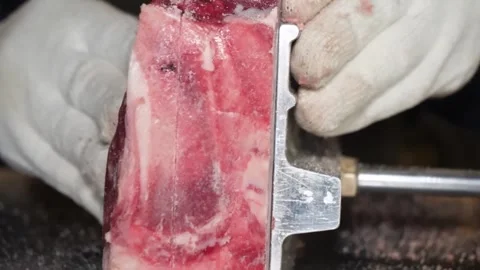 Professional Butcher Cutting Beef Ribs with Industrial Bone Saw Machine Stock-Footage 332814366