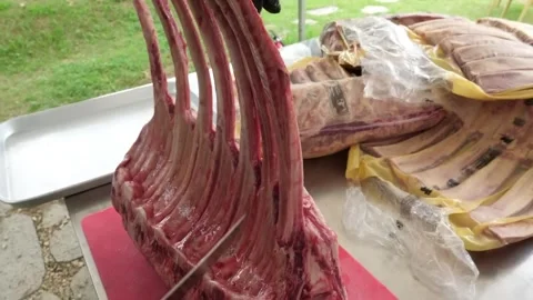 Professional Butcher Preparing Large Raw Marbled Prime Rib Roast for Barbecue Stock Footage 338212897