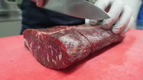 Professional Butcher Slicing Premium Marbled Beef Steak on Cutting Board Stock Footage 337678480