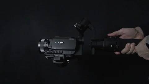 Professional camcorder rotating horizontal 360 degrees on DJI Ronin S stabilizer Stock Footage 124424302