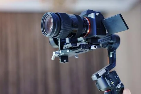 Professional camera on electronic gimbal stabilizer Stock Photos