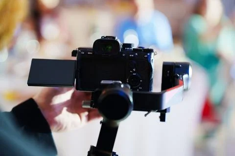 Professional camera on handheld gimbal stabilizer Stock Photos