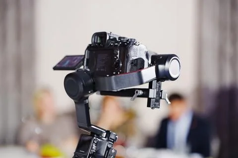 Professional camera mounted on gimbal stabilizer Stock Photos