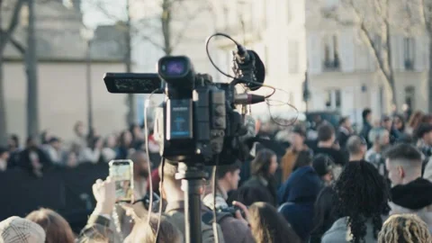 Professional camera recording a crowd at a public event in city Stock Footage 305355844