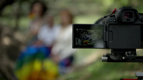 Professional camera recording LGBTQ pride lifestyle scene with rainbow flag Stock Footage 341078037