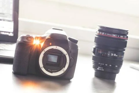 Professional camera: Reflex camera with open sensor. Lenses in the backgro... Stock Photos