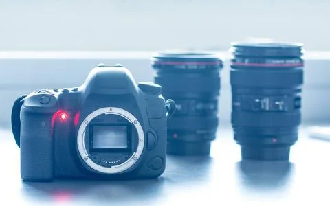 Professional camera: Reflex camera with open sensor. Lenses in the backgro... Stock Photos