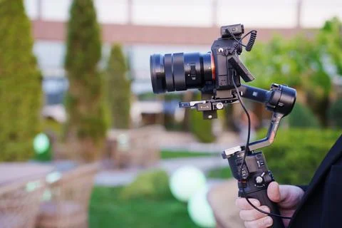 Professional camera setup for event filming in outdoor garden setting 스톡 사진