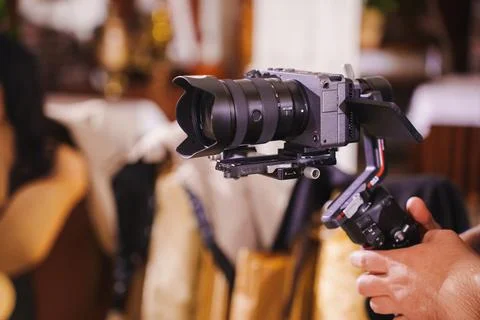 Professional camera setup for videography in a lively restaurant setting Foto stock
