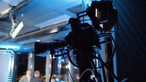 Professional camera stands on a tripod in a tv studio Stock Footage 121369319