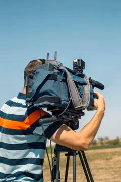 Professional cameraman working with video camera Stock Photos