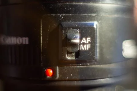 Professional canon camera focus mode switch detail with red indicator light 스톡 사진