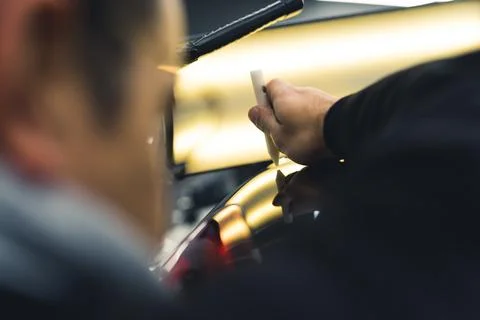 Professional car dent removal process. Focus on specialistic pen. Indoor closeup Stock Photos