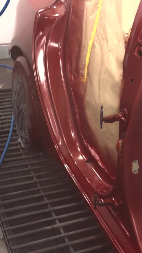 Professional car door painting process in a clean spray booth environment Stock Footage 339326946