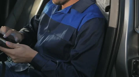 Professional car mechanic working in modern auto repair service and checking Stock Footage