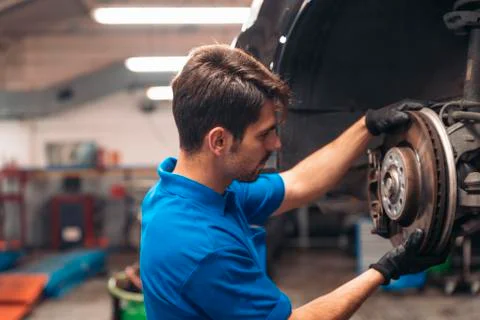 Professional Car Mechanic working. Stock Photos