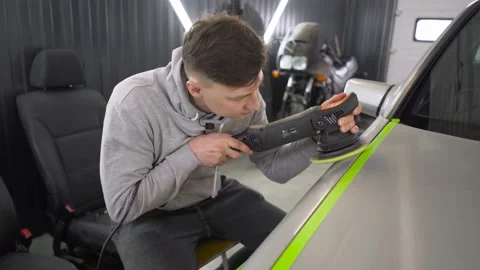 A professional car polishing master, using a polishing machine and paste Stock Footage 161645491