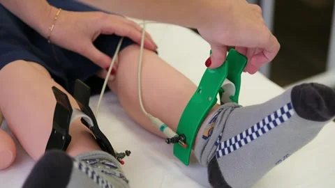 Professional cardiologist performing an electrocardiogram test by placing Stock Footage 319631635