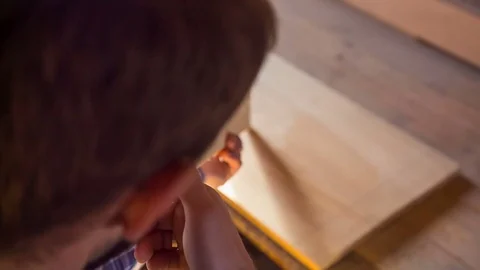 A professional carpenter chooses the perfect board in the joinery shop. Joiner's 스톡 동영상 85325344