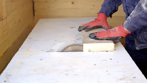 A professional carpenter cuts wood with a circular saw. Stockbeeldmateriaal 264018932