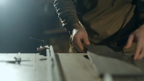 A professional carpenter is defining the right position of a rectangular piece Vídeos de archivo 99606122