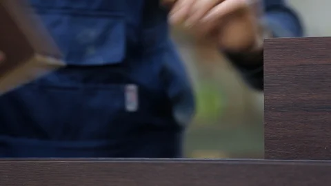 Professional carpenter manually assembles expensive composite door, close-up Stock Footage 128389961