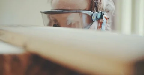 Professional Carpenter In Protective Glasses Examining Wood Video stock 75874221