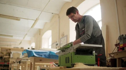 Professional carpenter using electric planing machine Stock Footage 101795376