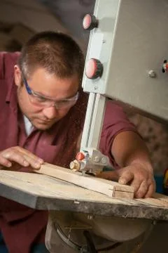 Professional carpenter working with sawing machine. Stock-Fotos